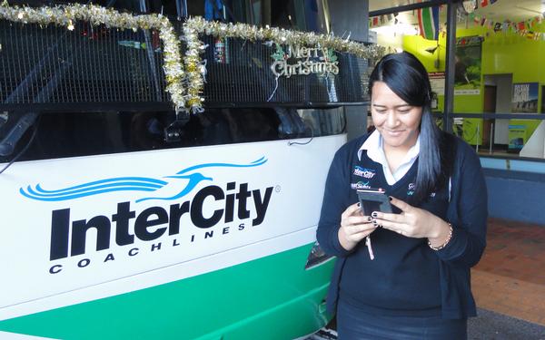 An InterCity staff member tries out the new Google Maps feature on her mobile at the company's main Auckland terminal.
